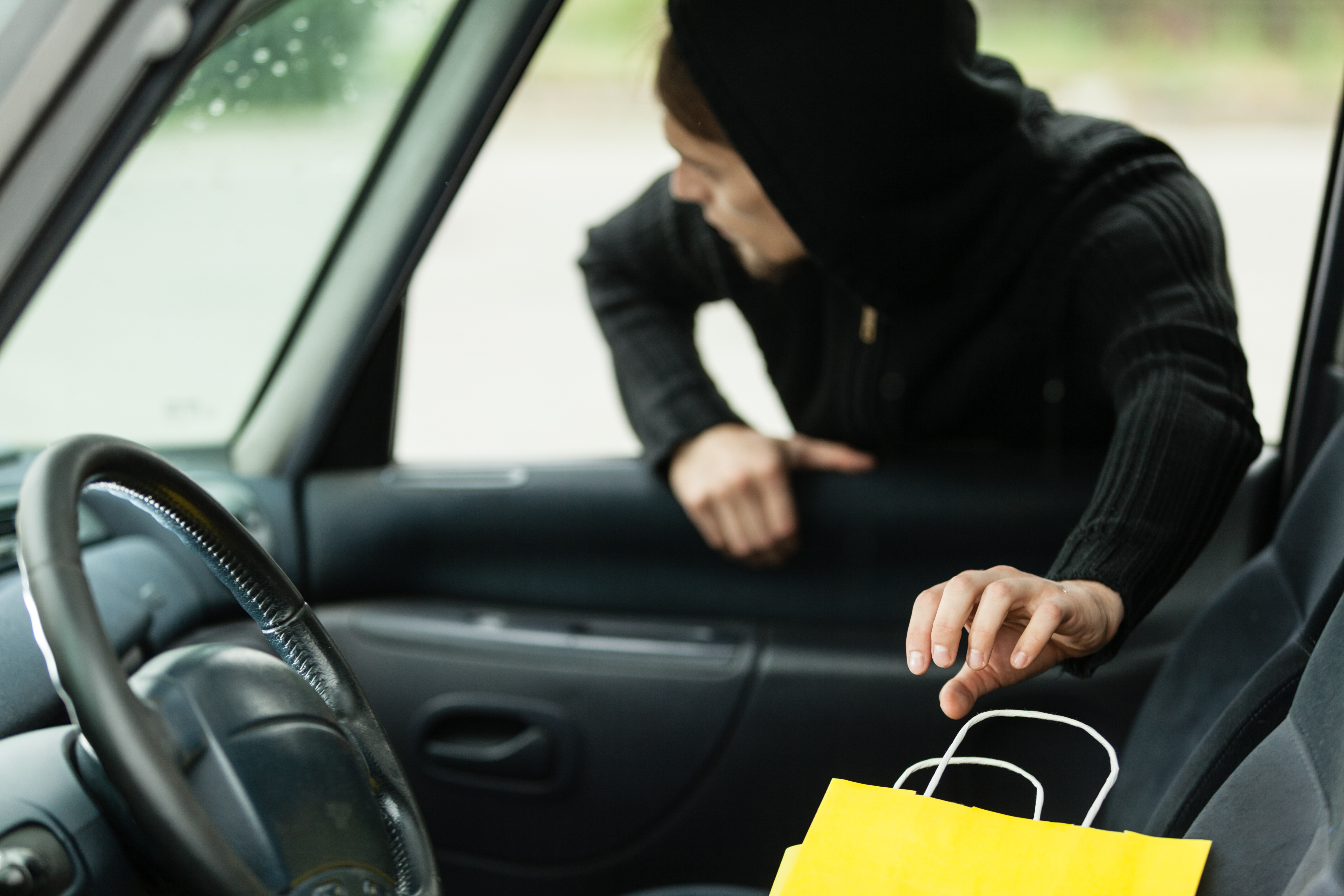 Man stealing a shopping bag - shoplifting crimes